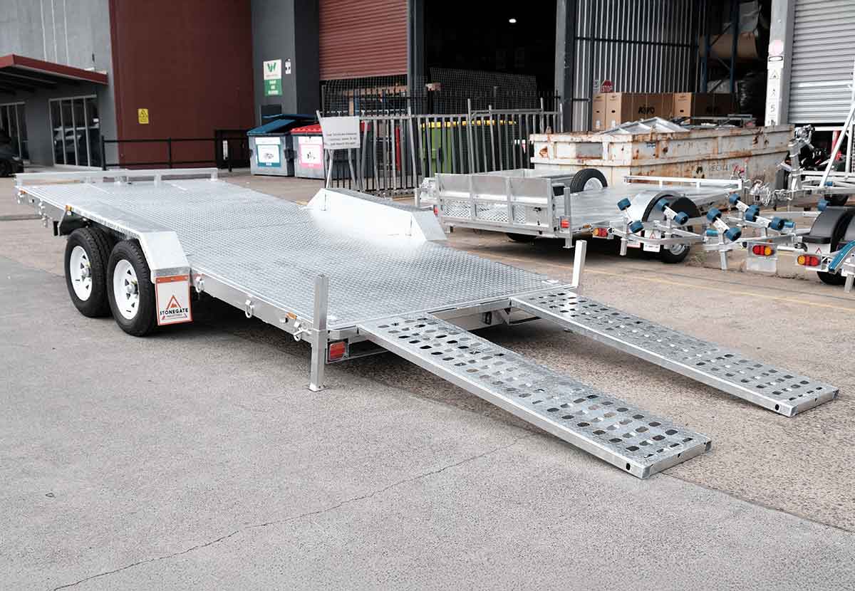 Car trailer with loading ramps lowered