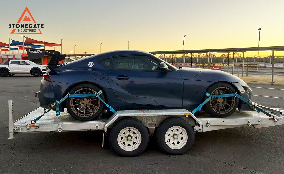 Car secured on the twin-axle car trailer